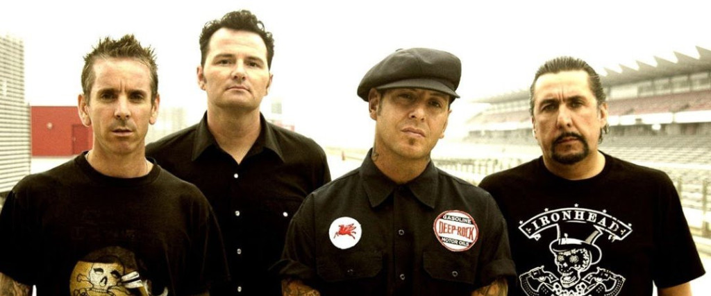 Social Distortion In the late 1970s the first raw, sloppy, speeding guitar chords began to blare from the garages and backrooms of a Southern California suburb called Orange County. They echoed a sound forged in the preceding years in the seminal punk undergrounds of New York City and London. In 1979, 17-year old Mike Ness formed Social Distortion with drummer Casey Royer and brothers Rikk and Frank Agnew. The band’s world centered around Mike’s one-bedroom pad, dubbed “the black hole” (later immortalized by the The Adolescents with the song “Kids Of The Black Hole”), in a nondescript Fullerton, CA apartment complex. After meeting Dennis Danell, whose brother worked in West Hollywood at The Starwood, (a club instrumental in the careers of Black Flag, The Germs, The Go-Gos and many more) Ness insisted Danell, who at the time didn’t play an instrument, join the band on bass. Royer and the Agnew’s soon split from the band and eventually formed The Adolescents. Local Los Angeles KROQ-FM deejay Rodney Bingenheimer embraced Orange County music, playing many bands from the scene on his Sunday night radio show. In 1981, Social Distortion released their first single, “Mainliner/Playpen,” on the Posh Boy label. Around the same time, Mike Ness developed a reputation as a brawler resulting in a chunk of his left ear being bitten off during a confrontation at the Cuckoo’s Nest bar. In 1982 Social Distortion embarked on their first cross-continental tour in a run down old school bus. Joined by LA’s Youth Brigade and DC’s Minor Threat, the tour became the subject of the now legendary documentary “Another State of Mind.” Much madness ensued, due in no small part to Ness’s growing heroin habit. By late 1983, Social Distortion’s line up consisted of Mike Ness, Danell (now on rhythm guitar), bassist Brent Liles, and drummer Derek O’Brien. Their debut album Mommy’s Little Monster was released on the 13th Floor label and gained the band a national name in punk circles. By this point Ness’s heroin use had become a full-fledged addiction and resulted in Brent Liles and Derek O’Brien bailing out of the band in the middle of a New Year’s Eve 1983 show. After their departure Ness and Danell recruited John Maurer, another old school buddy from Fullerton to play bass and Christopher Reece, of the San Francisco band The Lewd, to play drums. This lineup weathered Social Distortion’s toughest years, as Ness struggled with addiction and the resulting series of jailings and detoxes. Somehow Ness is continued writing and managed to hold the band together. In 1985 they to began work on a new album. It took a while to complete, but in 1988, Social Distortion emerged with Prison Bound, an album whose moving title track about a wasted life is one of the greatest songs ever to come out of Orange County. From this point Ness turned Social Distortion’s albums into an ongoing dialogue about impulsiveness, its consequences and the hard struggle to overcome. In addition to the early punk of The Ramones and The Clash, the band’s sound was culled equally from Ness’ love of roots music, specifically early country music greats like Hank Williams and the early blues recordings of the South such as Muddy Waters, Lightnin’ Hopkins and Howlin’ Wolf. As Ness would later declare to Social Distortion audiences, “Without good black music, there would be no good white music.” The self-titled album Social Distortion followed in 1990. It marked SD’s first release on a major label. The success of singles “Story Of My Life” and “Ball And Chain,” along with their remarkable cover of Johnny Cash’s “Ring Of Fire,” make the album Social Distortion’s first Gold record. The band is asked to join Neil Young on tour, beginning the process of bending punk expectation. In 1992 they released another new album, Somewhere Between Heaven and Hell. Lead by the blistering single “Bad Luck,” this album also goes Gold. Following the success of “Bad Luck” at radio, Social Distortion embarked on a co-headline tour with The Ramones. alternative rock Punk punk 'n' roll skate punk socal pop punk