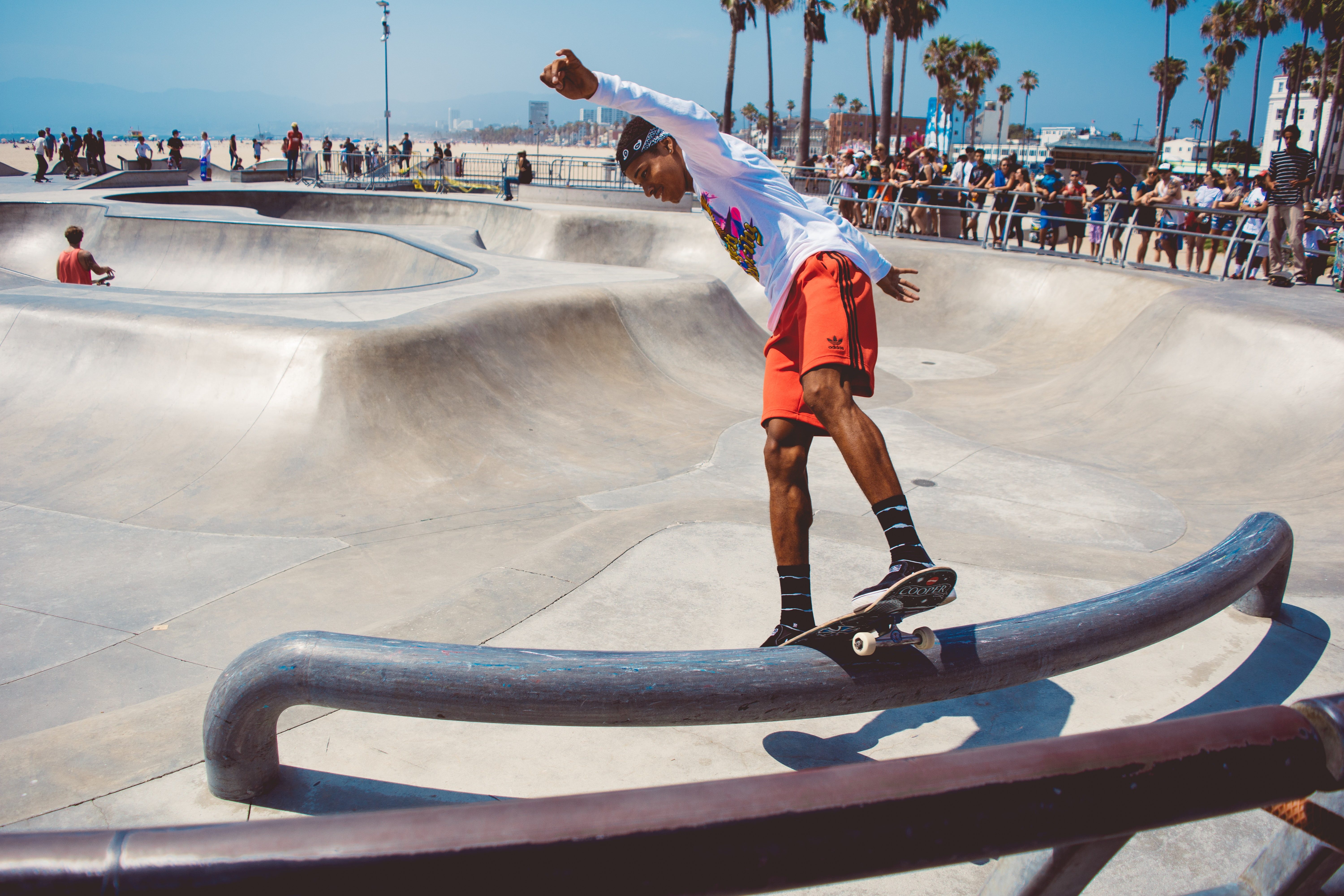 Frontside board slide at the Venice Beach skatepark. person on skate