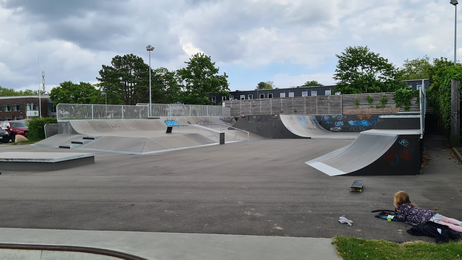 Hørsholm skatepark is a newly built made of black wood and steel on a concrete foundation. The park’s quarter pipes and banks are placed at the edge of the park so that skaters can maintain speed and flow throughout the park. In addition, the obstacles of the park are made of wood so that it is possible to move them around if needed. There is also a large manual pad course with more quarters and grind boxes.The park is definitely worth a visit as the quality of the park and its design is very professional. The transfer course is probably the most unique element of the park. Here, there are both quarter pipes, banks, spines and ledges. This course is perfect for doing airs, transfers and grinds. The park’s mini vert is on the other side. Here, there are great opportunities for you to practise your tricks and the mini vert appeals to all skaters regardless of their level as it is 1,5 metres high.Hørsholm Skatepark has been expanded with a bowl. You can see the bowl in some of our pictures. The bowl is located at Stadionallé 7. The bowl is designed by FRS Beton together with Beaver Concrete. Wonder Concrete and Enr have established the low part of it as well as the mini ramp.Pivotech enriched us with a lot of skateparks: Kolding Skatepark, Feldballe Skatepark and MPH to mention some of them.You can follow Pivotech and their projects on facebook.This expansion was described in August, 2014.