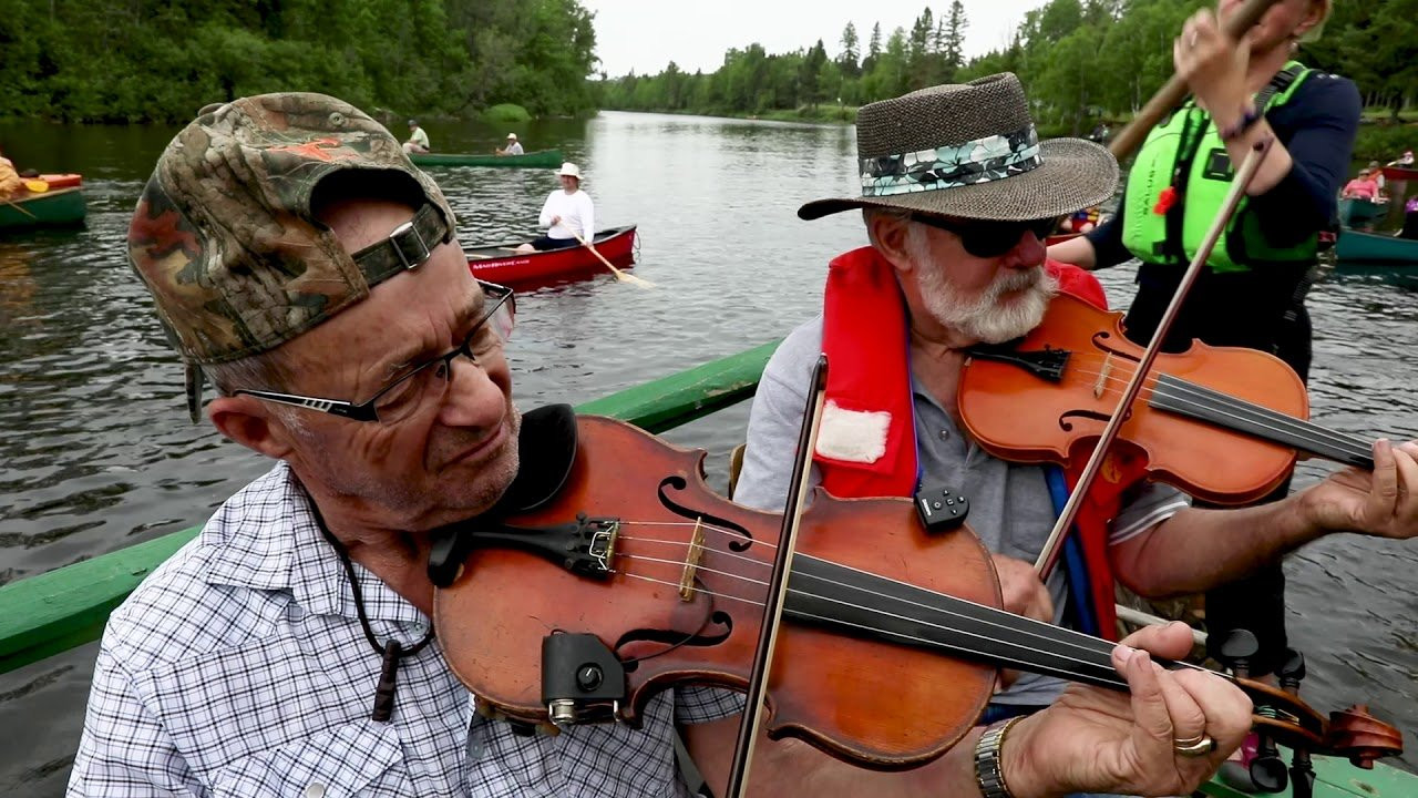 In 1994, Bill Miller took a small crew of fiddlers in his handmade, wooden canoes down a section of the Tobique River from his family's historic shop in Nictau, New Brunswick. So delighted were he and the fiddlers at the harmonious combination of river, fiddle, and canoe that the group decided to meet again the next year. Dubbed em Fiddles on the Tobique /em , the low key event grew in numbers, peaking in years where canoe's would number in the thousands and dozens of fiddle's would echo through the valley for a celebration of music and joy. After 25 years and as many events, Bill Miller beams at the mention of his days when his small hamlet of ten people would swell into the thousands and his log cabin over flowed with laughter and music. When asked, year after year, Miller would insist "This was the best Fiddles on the Tobique ever."<br /><br />See more at candk.me/fiddles -- <br />http://www.canoekayak.com/videos<br />https://www.youtube.com/user/canoekayak/videos