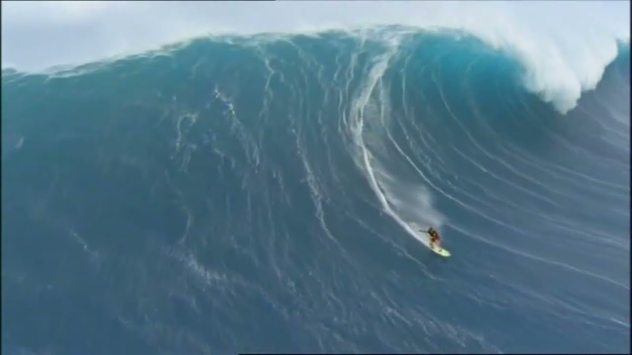 In one of the best surfing moments ever captured, Mike Parsons gets towed into a massive wave at Jaws, Maui, Hawaii. Tow partner: Brad Gerlach. 35mm cinematography: Peter Fuszard. Helicopter pilot: Don Shearer. From the early days of the quest for the 100 foot wave. Visit https://bigwavemerch.myshopify.com for hoodies and tees.