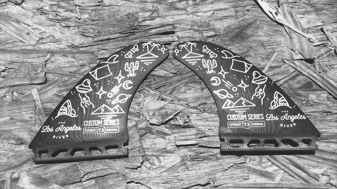 FUTURES ALONG WITH LOS ANGELES BASED TATTOO ARTIST, STEPHEN CARBALLO, CAME TOGETHER TO COLLABORATE ON FUTURES. T2 TWIN TEMPLATE IN OUR CUSTOM SERIES LINE. CUSTOM SERIES IS OUR PRECISION CNC-CUT, HAND FOILED LINE OF FINS PRODUCED IN OUR FACILITY IN HUNTINGTON BEACH, CA. WHAT OTHER WAY TO HAVE IT MORE CUSTOM THAN HAVING A LIMITED RUN OF OUR T2 WITH CUSTOM HAND DRAWN ART WORK BY THE LOS ANGELES RIVER TATTOO ARTIST. THIS TEMPLATE FEATURES A LARGE SURFACE AREA AND UPRIGHT DESIGN, ALLOWING FOR TIGHT TURNS IN THE POCKET, AND ELIMINATES THE NEED FOR A STABILIZING FIN IN THE REAR. THE BASE OF THE FIN REMAINS STIFF FOR MAXIMUM DRIVE, WHILE THE TIP IS THINNED OUT, ALLOWING THE FIN TO FLEX AND PROVIDE THE RIDER WITH A RESPONSIVE FEEL. THE T2 IS BEST SUITED FOR MR STYLE TWIN FIN BOARDS.