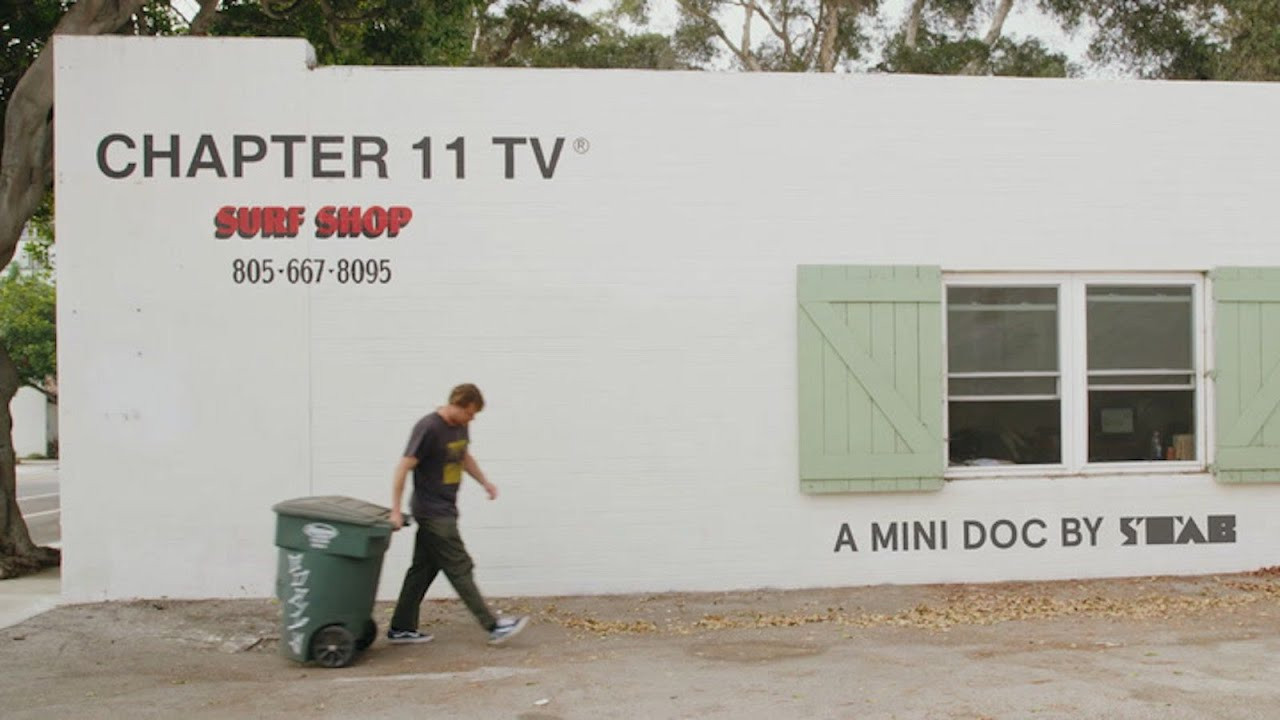 On the 27 Nov 2024, Dane Reynolds' opened a new Chapter 11 shop x Former HQ on 83 S Palm Street, Ventura, just down the road from his old one. In the spirit of new beginnings we thought we'd release our mini-doco on Dane and his original shop, directed by Michael Cukr. <br /><br />____________________________________________________________________________________________<br /><br />Is it too meta for a surf media company (Stab) to cover another surf media company (Chapter 11 TV)?<br /><br />Perhaps — but, frankly, for the past two decades all surf media has been interested in almost anything Dane touches. In the words of Stab Premium commenter Kama’aina: “Is Dane ever going to do something that will allow my fanboydom to falter?”<br /><br />Last week, we released an interview with Dane that was strictly surfboard-centric, revolving around the release of the Dumpster Diver 2 — a revamped rendition of Dane’s lore-filled steed of choice.<br /><br />The interview also touched on Chapter 11 TV‘s skit ad, which has gone just about as viral as a surfboard ad can go (50K organic views).<br /><br />But this week, we’re releasing a mini-documentary — that we partnered with filmmaker Michael Cukr on — that that delves into Dane’s life and projects (of past, present, and future).<br /><br />Here are just three of our takeaways from our admittedly sycophantic search into Dane’s brain:<br /><br />One, Dane’s career seems more fulfilling to him now than it’s ever been before — “I think Glad You Scored was the best film I’ve done,” Dane told us, “documenting the parts where nothing is coming together is when storytelling is the most fun.”<br /><br />Two, surf videos are the end-all and be-all of a surf media company’s function — at the end of the day, all Chapter 11 TV (and Stab for that matter) does is tell stories and entertain people well enough to (hopefully) merit their time and money.<br /><br />And three, Despite Dane’s modest MO — still wears shoes with skate-tears in them, takes out the shop’s trash, and small talks with mom-and-grom groups at the cash register — he is a brilliant and shrewd curator of media, brand identity, and story creation.<br /><br />Lest we forget, this is the guy who at one point in his career was making $300,000 a month to ride waves. This is not your standard 30-something, half-baked surf shop manager.<br /><br />We hope you enjoy this brief glance at Mr. Reynolds and his family, Ventura, Marine Layer Productions, Chapter 11 TV, Emma Wood’s wedgy “junk”, and finding Goldfish in your shoes.