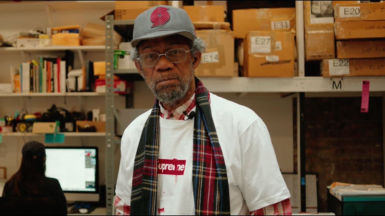 American artist Pope.L was born in Newark, NJ in 1955. He began graduate studies at Rutgers in the late 1970s, developing an interest in experimental theater and performance. His actions largely occur in public and municipal spaces — many of which have taken place in New York, including at Tompkins Square Park and outside of a midtown Chase Bank. Referring to himself as “a fisherman of social absurdity,” Pope.L has employed a variety of strategies to explore complicity, power, race, class, gender, and embodiment. His work spans theater, intervention, painting, drawing, sculpture, installation, writing and video. It is at turns provocative, absurd, disruptive and vulnerable.<br /> <br />Some of Pope.L’s most well-known work are his arduous “crawls,” a series of street performances enacted over four decades. He first crawled across 42nd Street in 1978, inspired by growing numbers of unhoused people sleeping on the street. In re-focusing collective attention on his own body moving through space horizontally, he considered “all those folks, who seemed inert and unwilling to lift themselves up by their bootstraps, starting to move as one,” and how such refusal to move up contains “this energy of moving forward.” <br /> <br />Between 2001 and 2009, Pope.L incrementally crawled 22 miles up Broadway, from the tip of Manhattan to the South Bronx, wearing a Superman costume and a skateboard on his back. These actions pose important cultural and historical questions. What gestures are accepted in what spaces? Whose gestures are accepted in whose spaces? How does a space frame an action? “As soon as you go outside, there’s this issue of where you are in space, and who owns that space,” Pope.L has said. “So I realized that I was setting up a tension when I crawled about being in space and how you’re located in that space – how you’re supposed to behave in that space, and who can own that space, and how you can own it.”