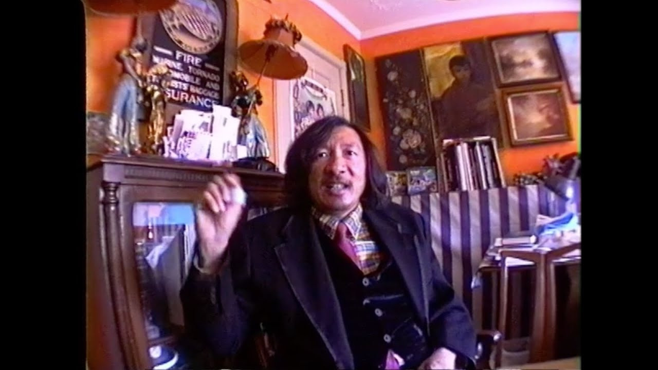 Martin Wong as told by Chris “Daze” Ellis and Lee Quiñones. Original video by Charlie Ahearn.<br /><br />Chinese-American artist Martin Wong was born in 1946 and raised in San Francisco. In 1968, Wong earned a degree in ceramics from Humboldt State University, where he enrolled in every art course available. After college, he designed sets, props and flyers for radical queer performance art troupes The Cockettes and Angels of Light. Wong moved to New York City in 1978. He lived and worked in an SRO hotel near the South Street Seaport before settling in Loisaida – the Lower East Side’s historic Hispanic enclave – in 1982.<br /><br />Overlooking his adopted neighborhood from a six-floor walkup on Ridge St., Wong documented the vibrancy and desolation of life in mid-80s Loisaida. Informed by his ceramics training, he developed a meticulous painting technique to realistically render the neighborhood’s brick buildings. Wong also developed a collaborative relationship with Nuyorican poet and playwright Miguel Piñero, whose experiences in prison and on the streets profoundly shaped Wong’s work and romantic outlook. Obsessed by codes of communication, Wong energized his artworks with Piñero’s poetry, Zodiac constellations, calligraphy, newspaper headlines, sign language alphabets, hand-painted signs and graffiti. “Basically, I’m a Chinese landscape painter,” Wong told the East Village Eye in 1984. “If you look at all the Chinese landscapes in the museums, they have writing in the sky. They write a poem in the sky and I do that, too.” Additionally, Wong was a strong supporter of New York graffiti writers. In 1989, he co-founded the short-lived Museum of American Graffiti on Bond St., and later donated his extensive graffiti collection — including work by Daze and Lee Quiñones, among many others — to the Museum of the City of New York.<br /><br />In 1994, after learning he was HIV positive, Wong returned to San Francisco to receive treatment. There, he made paintings depicting the Chinatown of his youth, and continued building a vast antique collection with his mother, Florence. In 1999, Wong passed away from AIDS-related complications; he was 53-years-old. His paintings, wrote curator Barry Blinderman, “charted a world of unquenchable desire – the steadily burning flame of unrequited love, the junkie’s endless craving for oblivion, the poet’s wheel of misfortune, the alchemist or astrologer’s quest for meaning in the elements and stars.”