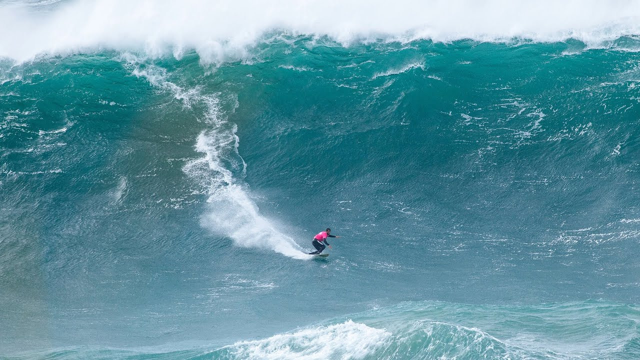 The 2025 Nazaré Big Wave Challenge brought fierce competition to Portugal’s Praia do Norte, where surfers tackled waves up to 35 feet tall.<br /><br />Organized by the World Surf League (WSL) and sponsored by TUDOR, the event tested athletes with strong winds and choppy conditions.<br /><br />Teams relied on teamwork, jet ski skills, and quick decision-making to ride the massive waves.<br /><br />Winners Rise Above Challenges<br /><br />French surfer Clement Roseyro claimed the Men’s Best Performance Award, scoring 21.83 points.<br /><br />Partnering with Portugal’s Nic von Rupp, the duo also won the Best Team Performance Award.<br /><br />Roseyro credited their success to teamwork: “Nic taught me jet ski skills, and we push each other.” Von Rupp added, “We trained hard this year. Last season, we should’ve won—this makes it sweeter.”<br /><br />Brazil’s Lucas Chianca, a past champion, took second place, while Scotland’s Ben Larg surprised as a last-minute replacement, finishing third.<br /><br />Larg impressed with sharp turns on steep waves, proving his skill in “tow-in” surfing—where a partner uses a jet ski to pull a surfer into position.<br /><br />Women’s Division Highlights<br /><br />France’s Justine Dupont returned after having her first child, riding eight waves with bold lines.<br /><br />“Motherhood shifted my focus,” she said. “I worry about my baby now, not fear.”<br /><br />Her teammate Eric Rebiere struggled, catching only one wave. Brazil’s Michelle des Bouillons took second, guided by partner Ian Cosenza.<br /><br />British newcomer Laura Crane also stood out, towing Portugal’s Antonio Laureano into large waves.<br /><br />Conditions Test Limits<br /><br />Strong winds created uneven wave faces, forcing surfers to adapt. Brazil’s Pedro Vianna, last year’s team winner, noted, “Choosing the right waves was key—it wasn’t easy.”<br /><br />Many wiped out but stayed persistent, aiming for high-scoring rides.<br /><br />The event showcased Nazaré’s reputation as a big-wave hotspot, blending danger and skill. As Roseyro put it, “It’s about trust—in your team and your instincts.” With thrilling rides and close calls, the 2025 challenge proved why this location remains a ultimate test for surfers worldwide.<br /><br />Footage: Red Bull