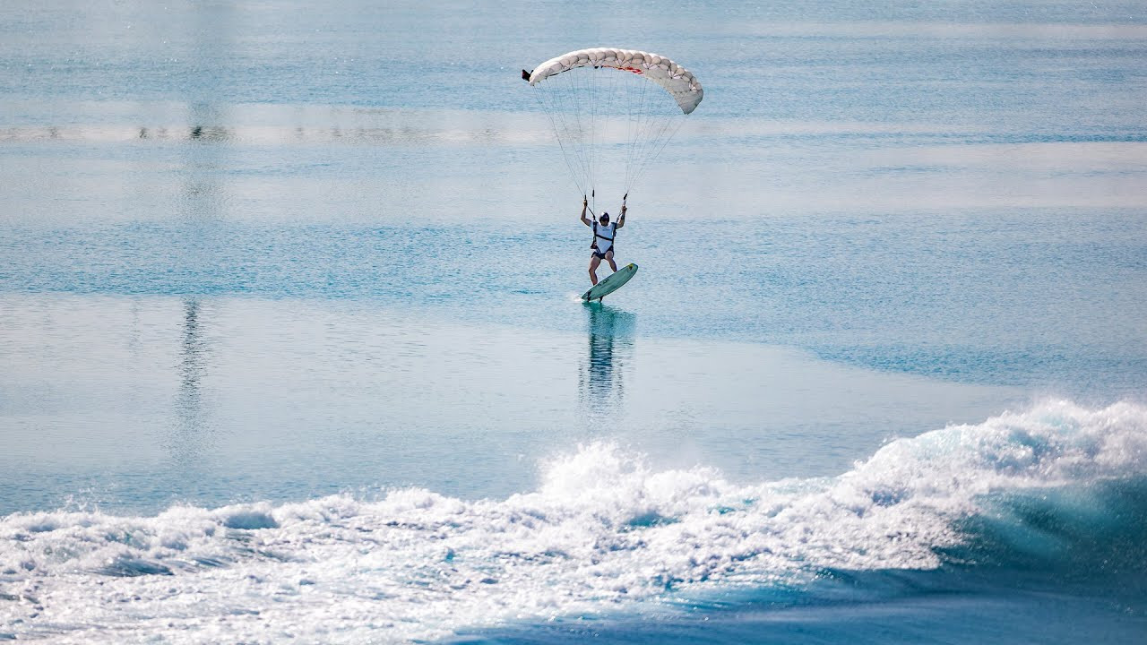 Chilean wingsuit flyer Sebastián Álvarez took a daring leap from a Bell 212 helicopter at 12,000 feet (3,657 meters) above Hudayriyat Island in Abu Dhabi before descending in spectacular fashion and landing on a wave.<br /><br />With a specially modified surfboard attached to his feet, Álvarez skysurfed from the helicopter, gliding down by parachute.<br /><br />As he neared the world's largest wave pool at Surf Abu Dhabi, he cut his parachute and smoothly landed on a six-foot (1.8-meter) wave.<br /><br />A world-class BASE jumper and skydiver, Álvarez has completed thousands of similar jumps, but this one was particularly bold and unique.<br /><br />The project, which took over two years to develop, combined three extreme sports: sky surfing, swooping, and surfing. The preparation required mastering all three, creating a high-level, multidisciplinary challenge.<br /><br />Álvarez explained that the idea had been in his mind for a long time, inspired by watching pelicans gliding over ocean waves as a child. He admired the birds’ ability to use the wind and waves to maintain speed and grace, imagining himself one day doing the same. <br /><br />With the advanced wave technology at Surf Abu Dhabi, developed by the Kelly Slater Wave Company, Álvarez’s dream became reality.<br /><br />The facility, which boasts the longest artificial wave and largest barrel, provided the ideal location for this groundbreaking feat.<br /><br />Surf Abu Dhabi is one of the world’s latest year-round surfing destinations, attracting adventure seekers and sports enthusiasts.<br /><br />Álvarez reflected on how special it was to complete his project in Abu Dhabi, calling the technology behind the waves a remarkable human achievement.<br /><br />"It truly is a perfect wave," he said, adding that accomplishing this daring jump felt like stepping into the unknown and fulfilling a lifelong dream.<br /><br />Surf Abu Dhabi is set to host its first major event, the 2024 Abu Dhabi Longboard Classic, on September 27-29, with a World Surf League Championship Tour event scheduled for 2025.