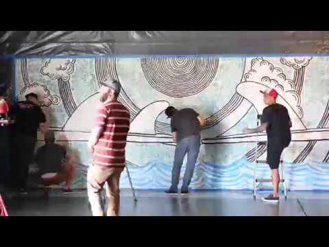 At #HurleyHQ, a white wall doesn’t say that way for long. Hurley’s Design Director for Printables, Ross Pruitt, explains the inspiration behind the latest mural to hit our halls: <br /> <br />“The inspiration from the drawing came from a photo of one our teammates who was on a boat trip through the Mentawais. Sitting on the stern of the boat, he loved how pure the board and fins looked against the raw elements of the sea. This vision, combined with a slight tattoo influence in the clouds and bits and pieces from other designers came together in the creation of this piece.”<br /> <br />Like this graphic? Find it on the Hurley Finset tee, available at select retailers.