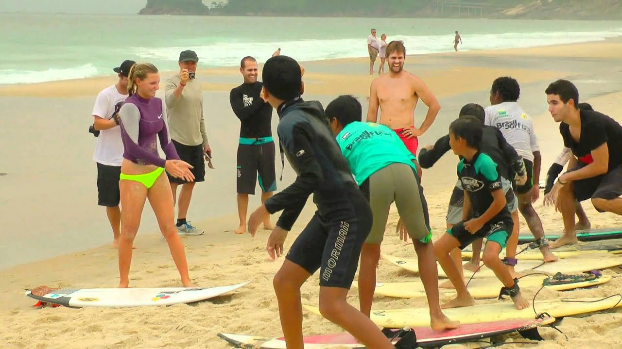 American pros -- Austin Ware, Pat Gudang, Lakey Peterson, plus Damien and CJ Hobgood -- got together to throw on a surflesson for the grommets between heats in Rio.<br /><br />It went down at Sao Conrado, the next beach past their hotel, where the crew had all been free-surfing most days. The hills behind Sao Conrado are home to the Rocinha favela and the special morning was put together by Ricardo "Bocao" Ramos and his team at Rocinha Surf School.<br /><br />As it was a Sunday, the grommets had been pacing the beach since dawn, frothing for the lesson, including one little termite who went so berserk in the sherry that he ended up breaking his board.<br /><br />The surf school has been doing amazing stuff for the kids of Rochina since 1994, such as providing them the chance to meet their heroes. According to local grom, Gabriel: "It's really cool, because sometimes here in Rocinha we don't have many opportunities, but now we have surfing and it's such a cool sport that people want to participate in."<br /><br />"It's more than a surf school," say Bocao. "It's a school of life."<br /><br />A similar sentiment to Jean Carlos, who set up the Surf Gloria project over at the Cantagalo favela, where the goal is, "To give the kids something to do when they're not at school! To keep them active- because nowadays they are being influenced by a lot of bad things out there ... I prefer seeing a child with a surfboard rather than seeing them out there with a gun."