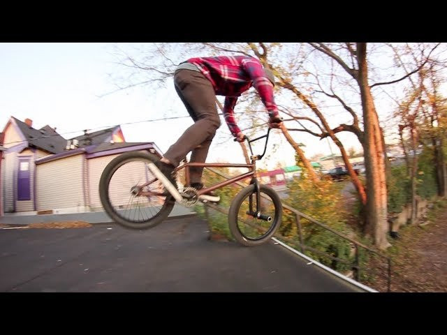 Nathan with a nollie pegs down a rail off a roof. Filmed in 2011.