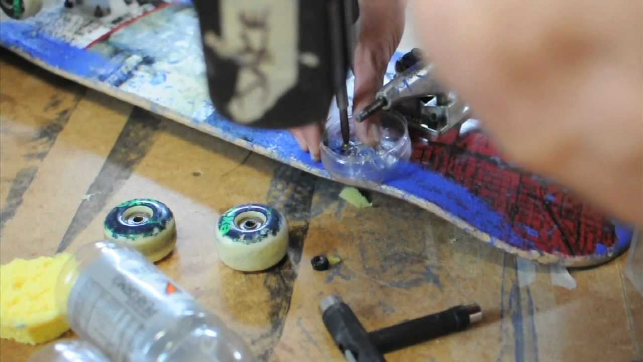 Jake Hauswirth modifying a skateboard to print ink via wheels and finishing a test mixed media print edition with it.