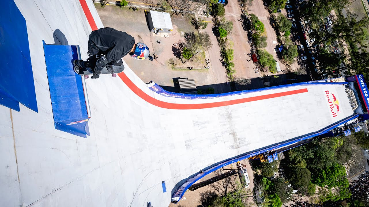 Brazilian skateboarding pro Sandro Dias made history, breaking two Guinness World Records after dropping in from Centro Administrativo Fernando Ferrari (CAFF), a 22-story building in Porto Alegre, southern Brazil.<br /><br />During the project, named Red Bull Building Drop, Dias hit a speed of 103 km/h, skating from a height of 70 meters with a drop of 60 meters, which was measured from the lowest point of the ramp to the platform.<br /><br />He surpassed the records he had set during training sessions leading up to the day of the drop, when he achieved a drop-in nearly six meters lower, and reached a top speed of 90.8 km/h.<br /><br />"The most important message I want to share is never give up on your dreams. This is a dream of more than 13 years that we've just achieved now, pushing the limits," Dias reflected after the final drop.<br /><br />With this feat, created in collaboration with Prada Linea Rossa, the 50-year-old Red Bull athlete brought to life a long-standing urban legend: transforming the building into the "Ultimate Skate Ramp" - a dream that has been shared for more than a decade through memes, fingerboard recreations, and even a spoof viral YouTube video 16 years ago.<br /><br />Through G-force, speed, and airbag safety training, the feat was the result of precise planning and calculated risk. Sandro trained with a 40-kilogram vest on a modified mega ramp and hit 136 km/h in airport tarmac speed tests.<br /><br />To step onto each platform, Dias was lowered numerous times from the building's rooftop using rappelling equipment - a harness and a rope secured at the top - assisted by experts, fully exposed to the elements.<br /><br />Throughout the feat, Dias carried out a total of four attempts, all successfully executed on the first try.<br /><br />The skater's final descent had never been attempted during training, underscoring his mental and physical fortitude as he ventured into uncharted territory.<br /><br />Officials from the Guinness World Records were present on site to verify Dias' feat and the records he set, awarding the Brazilian a certificate for "the tallest drop into a temporary quarter pipe," and one for "the fastest speed skateboarding on a temporary quarter pipe."<br /><br />To make the descent of the world's biggest ramp possible, plywood panels were constructed along the building's outer curve.<br /><br />The concrete surface beneath was weathered and cracked from years of exposure, making it unsafe for skateboarding in its natural state.<br /><br />The temporary overlay not only protected the building's façade but also allowed Dias to ride a smooth line from top to bottom, while fully utilizing the building's shape.<br /><br />Multiple safety measures were implemented to counter the potential risks associated with the feat, including MotoGP-style air fences - inflatable and energy-absorbing barriers designed to slow down riders in crashes - along the sides of the ramp.<br /><br />Additionally, 1,800 foam cubes were placed at the end of the ramp, allowing Dias to come to a safe stop. Dias's body equipment also included a full-face helmet and a spine protector, neither of which is traditionally used in skateboarding.<br /><br />Dias began an extensive physical and technical training program for the feat in January 2025.<br /><br />From G-force conditioning to wind-speed monitoring, the preparation was a mix of precision planning and calculated risk.<br /><br />Dias trained with a 40-kilogram weighted vest while dropping into a modified mega ramp to adapt his balance to the strain of G-forces. He also conducted speed trials on an airport runway, becoming accustomed to riding at more than 136 km/h on his skateboard.<br /><br />The skater added: "I prepared myself a lot for this. It wasn't easy, and the training was way tougher than this. That's why I was so confident."<br /><br />During Red Bull Building Drop, Dias endured a maximum G force of 3.9 g, making him weigh around 280 kilograms, which is also the weight that he experienced as the maximum ground reaction force - the push the ground sent back to him during the descent.<br /><br />The distinctive curved design of the CAFF building has long drawn comparisons to a giant skateboard quarter pipe, earning a reputation among locals as "the Ultimate Skate Ramp."<br /><br />For years, it fuelled speculation in Porto Alegre's skate community, inspiring memes, stories, and even a doctored video that showed a rider dropping down its side.<br /><br />Until now, it had remained just that: an urban legend.<br /><br />For Dias, the milestone went beyond any contest or record, serving as both a contribution to skateboarding's evolution and a tribute to its heritage.<br /><br />Tony Hawk, regarded as one of the sport's greatest figures, also hailed Dias' achievement.<br /><br />"If you look at the history of skateboarding, it continues to progress. It continues to keep getting better," said Hawk.<br /><br />"We keep pushing the limits of height, of speed. And now Sandro has jumped ahead about five times everyone else. You can go even bigger than we ever imagined."<br /><br />Footage: Red Bull