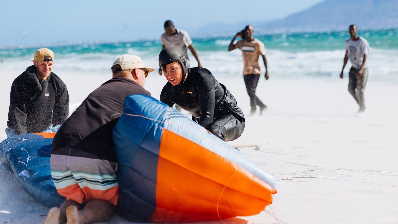 On December 6th, 2025, at 4:40 pm on Cape Town’s iconic Kite Beach, Hugo Wigglesworth launched himself into the sky and shattered a barrier that many believed wouldn’t fall for years: he became the first kitesurfer in history to jump 40 meters.<br /><br />The moment was captured, measured, and verified by WOO, the world’s leading big-air measuring device — using a small sensor mounted to Hugo’s foilboard to track the jump.<br /><br />The Night Before: A Braai, a Forecast, and a Feeling<br /><br />It all began the previous evening, when the Flysurfer crew gathered for a South African braai — a relaxed barbecue that quickly turned into a heated debate.<br /><br />The forecast was calling for violent evening gusts pushing toward 40 knots, the kind of wind that only true big-air riders dream about.<br /><br />Someone asked the question everyone was thinking about: Could Hugo break the world record tomorrow? Some nodded confidently, others shrugged at the madness of the idea, and Hugo simply smiled and kept his thoughts to himself.<br /><br />A Rider with Something to Prove<br /><br />Before the chaos of the historic jump, Hugo spent the morning in training.<br /><br />He had every reason to push harder than ever: he was one of the biggest upsets among the riders not selected for the 2025 Red Bull King of the Air — the most prestigious kitesurfing competition in the world.<br /><br />Since the moment the rider list was published without his name on it, Hugo had been on the water every day.<br /><br />After a focused hour of training, he came off the water, headed back to the Flysurfer house, made himself avocado on toast, and settled in front of the TV to watch Formula 1 qualifying.<br /><br />Even as the cars sped around the circuit, his eyes kept drifting to his phone to check the live wind updates. And then suddenly, Hugo stood up and said, “Let’s break a WOO World Record today.”<br /><br />Within seconds, the house erupted into purposeful chaos. Kite bags zipped, foil boards were loaded, wetsuits were thrown into cars, cameras and phones were plugged in for a last-minute charge. Hugo, his parents, and the Flysurfer team piled into their cars and headed straight for the beach.<br /><br />In a twist of irony worthy of a sports documentary, Hugo parked directly at the event site of the very competition he had not been invited to — one of the most famous kite beaches on Earth.<br /><br />A New Setup and a Sense of Destiny<br /><br />When the team arrived, Hugo’s mother and father set up his foil gear while Jamie Overbeek (the current second-highest jump on the WOO leader board) was already throwing massive jumps on the 7m SONIC⁵ with a twin twin — a very clear signal that conditions were escalating fast.<br /><br />Then came the small but crucial detail: Hugo had changed his setup. He’d replaced his 23-meter lines with a 17-meter configuraEon, a decision that was crucial for the course of the story.<br /><br />Hugo launched the kite with calm focus, carved out to sea, and lit up his very first jump on the new setup. The WOO registered 28-plus meters — an outrageous height for a warm-up, enough to make spectators pause and wonder what exactly they were witnessing.<br /><br />He kept jumping, each time going higher and cleaner, then tacked far outside and took off on a choppy kicker wave. Compared to his earlier take-offs, this one came in with nearly double the entry speed.<br /><br />Hugo edged hard, sent the kite with full commitment, and the world seemed to freeze for a second. Then the beach erupted in disbelief.<br /><br />In that moment, Hugo launched into what would soon be confirmed as the highest jump ever recorded in kitesurfing history.<br /><br />Hugo’s mother watched her son disappear into the sky and whispered, almost to herself:<br /><br />“This is the highest I’ve ever seen Hugo go in my life.”<br /><br />Yet even as the beach gasped and cheered, Hugo showed no reaction. No raised fist.<br /><br />No shout. No celebration. He simply rode back out, as if the impossible had just been another test run.<br /><br />The Whisper That Shook the Beach<br /><br />Ten minutes later, Hugo finally headed to shore. He landed his kite with the same calm focus he had launched with, walked toward his parents and the Flysurfer team, leaned in, and whispered:<br /><br />“I just went 40 meters.”<br /><br />No theatrics. No shouting. Just six words — delivered quietly.<br /><br />Hugo packed his SONIC⁵, slung it under his arm, and started walking toward the parking lot like someone who had finished a normal training day, not someone who had redefined the limits of human flight.<br /><br />But history has a way of spreading fast. Within minutes, the news erupted across the beach. Flysurfer riders, local media crews, podcasters, photographers, and even people who had already left came rushing back.<br /><br />The new world record holder grabbed a 6m ERA and ran to the beach with a big smile:<br /><br />“You can’t train double loops every day, can you?”<br /><br />What followed looked like a rider beginning his day, not finishing it: massive double loops, huge S-loops, explosive rotaTons.<br /><br />It was as if breaking a world record had simply opened the door to more possibilities, and Hugo wasn’t done exploring them.