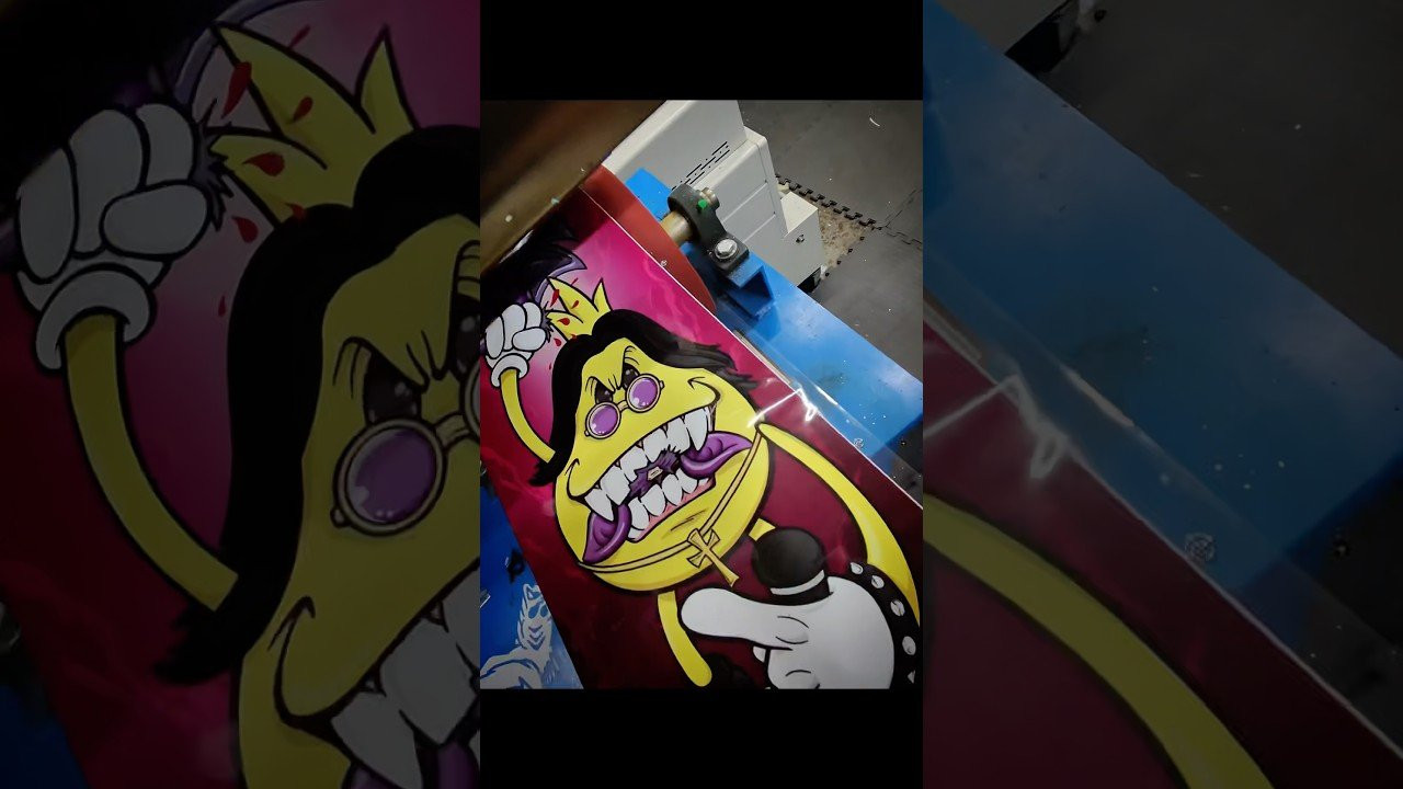 In this video, I’m taking you behind the scenes of the latest World Industries project! We are heat pressing a brand new, limited-edition tribute graphic featuring the iconic Flameboy. This time, Flameboy is paying homage to the Prince of Darkness himself, Ozzy Osbourne, by recreating the infamous 1982 bat-biting moment.<br />Watch the full process of bringing this custom skateboard art to life—from the initial design phase by the legendary @nickbarthe to the high-pressure heat transfer on our professional deck press.<br />In this video:<br /> Skateboard Manufacturing: A deep dive into heat pressing graphics onto pro-model maple decks.<br /> Custom Skate Art: How we scale high-fidelity designs for a 9" x 33" artboard.<br /> The Tribute: A unique mashup of 90s skate culture and classic rock history.<br />Get your own board here: worldindustries.com<br />Follow for more skate industry content:<br /> Instagram: @allineedskate / @ainskatedist<br /> Website: worldindustries.com<br />Credits:<br /> Artwork by: @nickbarthe<br /> Manufacturer: All I Need Skateboards<br />#WorldIndustries #OzzyOsbourne #SkateboardManufacturing #Skateboarding #Flameboy #CustomSkateboards #SkateGraphic #HeatPress #SkateLife #RandyRhoads #RockAndRollHistory #SkateboardDesign #SkateShop